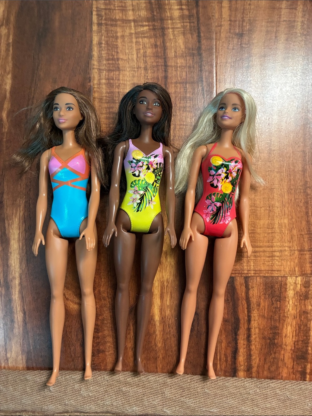 Barbie Trio in Turquoise, Yellow, and Red Floral Swimsuits